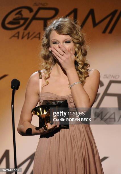 Taylor Swift celebrates after being presented with the Best Female Country Vocal Performance award for White Horse during the Pre-Telecast award...