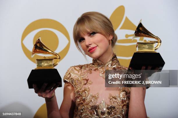 Taylor Swift poses with the trophies for the Best Country Solo Performance "Mean" and Best Country Song "Mean" at the 54th Grammy Awards in Los...