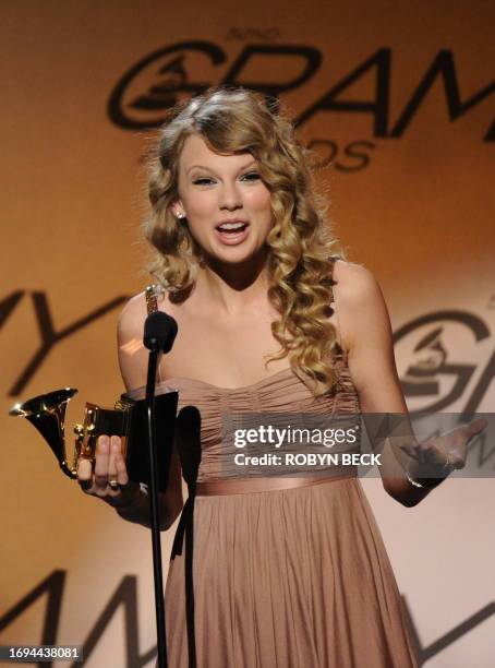 Taylor Swift celebrates after being presented with the Best Female Country Vocal Performance award for White Horse during the Pre-Telecast award...