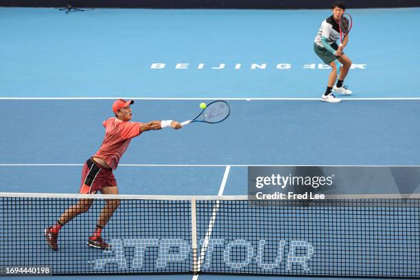 Jie Cui and Aoran Wang of China return a shot in their match against Karen Khachanov of Russia and Andrey Rublev of Russia during day 3 of the 2023...