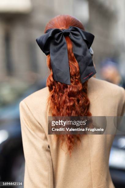 Evelyn Karantzoglou is seen red hair, a beige coat and a black bow wearing outside the Max Mara show during the Milan Fashion Week - Womenswear...