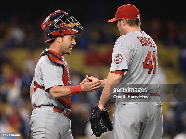 Tony Cruz of the St. Louis Cardinals and Mitchell Boggs celebrate a 7-0 win over the Los Angeles Dodgers at Dodger Stadium on May 24, 2013 in Los...