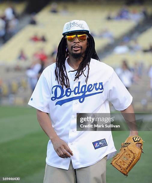 Rapper Lil Jon warms up before throwing out the ceremonial first pitch before the game between the St. Louis Cardinals and the Los Angeles Dodgers at...