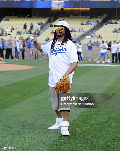 Rapper Lil Jon warms up before throwing out the ceremonial first pitch before the game between the St. Louis Cardinals and the Los Angeles Dodgers at...