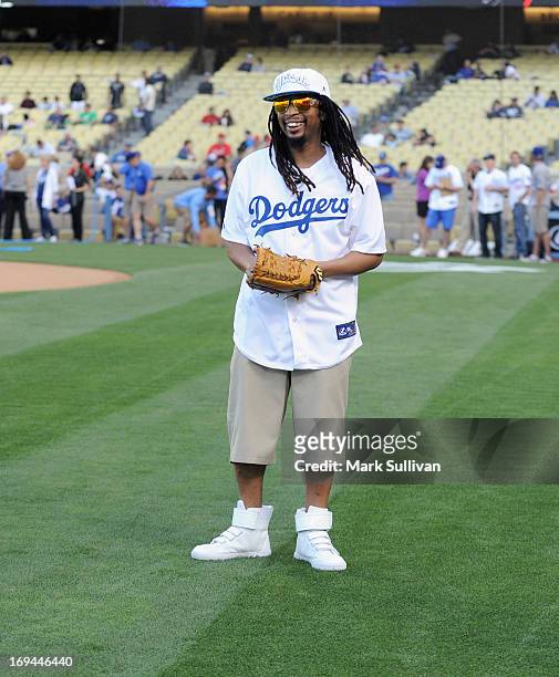 Rapper Lil Jon warms up before throwing out the ceremonial first pitch before the game between the St. Louis Cardinals and the Los Angeles Dodgers at...