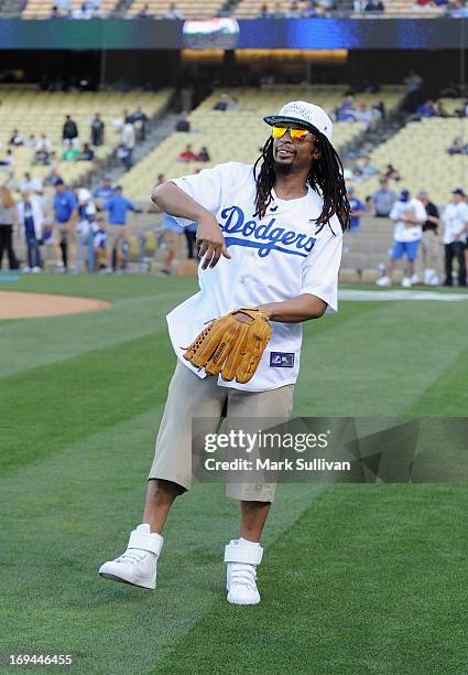 Rapper Lil Jon warms up before throwing out the ceremonial first pitch before the game between the St. Louis Cardinals and the Los Angeles Dodgers at...