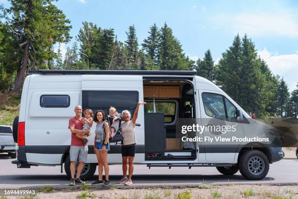 multigenerational family poses for picture in front of camper van - camper van stock pictures, royalty-free photos & images