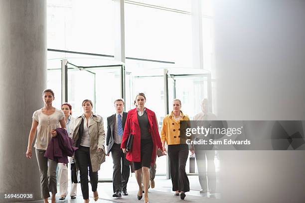 business people walking in lobby - arrival stockfoto's en -beelden