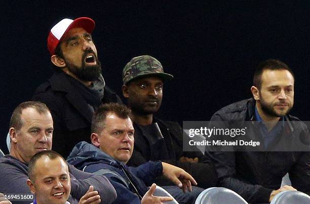 Adam Goodes of the Swans reacts while watching the game in the stands during the round nine AFL match between the St Kilda Saints and the Western...