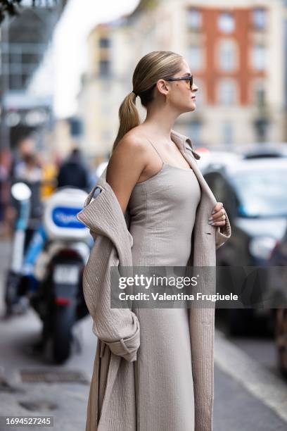 Valentina Ferragni is seen wearing tortoiseshell sunglasses, a long beige sequins dress and a matching long trench outside the Max Mara show during...