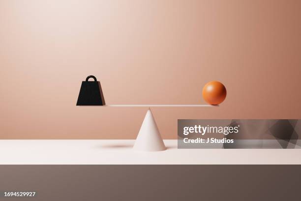 metal weight balancing with large orange sphere - beige concrete stock pictures, royalty-free photos & images