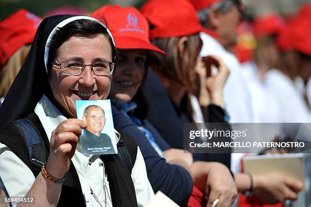 Nun shows a portrait of Father Giuseppe "Pino" Puglisi, an outspoken anti-Mafia advocate, during the beatification ceremony in Palermo on May...