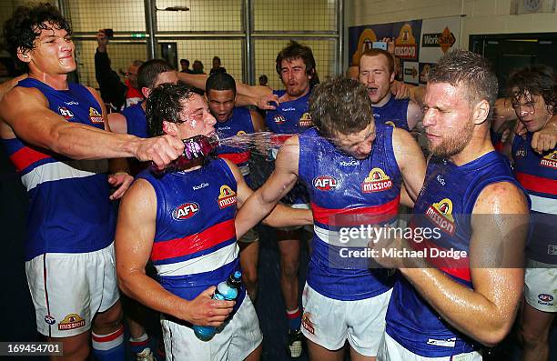 Will Minson of the Bulldogs pours drink over Nathan Hrovat, Jack Macrae and Jake Stringer after their win during the round nine AFL match between the...