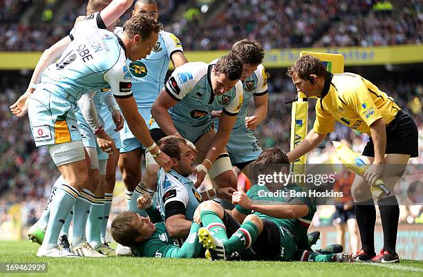 Stephen Myler of Northampton is congratulated by teammates after scoring his team's first try during the Aviva Premiership Final between Leicester...