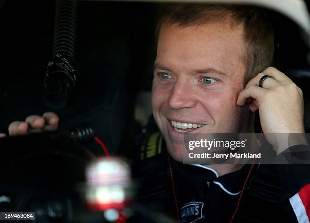 Regan Smith, driver of the Phoenix Construction Chevrolet, sits in his car during practice for the NASCAR Sprint Cup Series Coca-Cola 600 at...