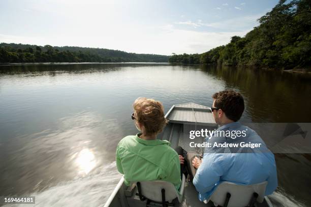 pov of man and woman in bow of boat on amazon. - manaus stock pictures, royalty-free photos & images