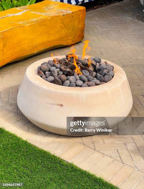 round concrete fire pit with flames - backyard gas fire stock pictures, royalty-free photos & images