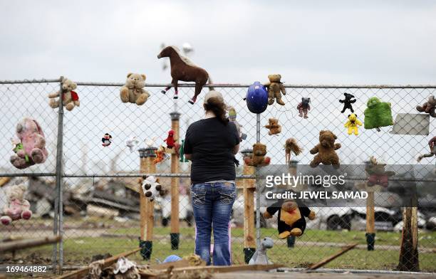 Stephanie Salinas visits a makeshift memorial with toys and crosses at the Plaza Towers elementary school in memory of the seven children who died...