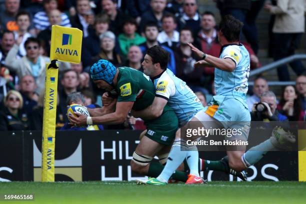 Graham Kitchener of Leicester dives over to score his team's second try despite the tackle from Ben Foden of Northampton during the Aviva Premiership...