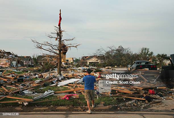 Matt Bedoe takes a moment to reflect in front of the home of his friend and co-worker Rick Jones, a 54-year-old postal worker, who died when his...