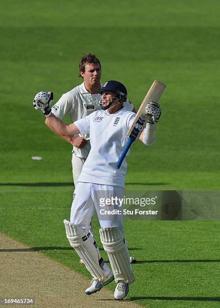 England batsman Joe Root celebrates his hundred as bowler Doug Bracewell looks on during day two of 2nd Investec Test match between England and New...