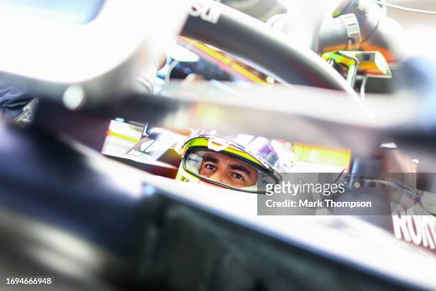 Sergio Perez of Mexico and Oracle Red Bull Racing prepares to drive in the garage during practice ahead of the F1 Grand Prix of Japan at Suzuka...