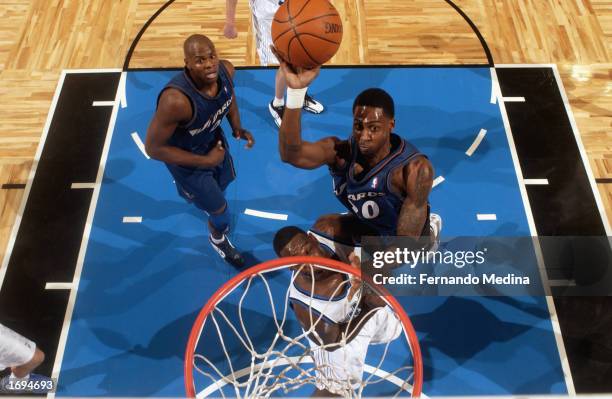 Larry Hughes of the Washington Wizards goes up for the shot over Shawn Kemp of the Orlando Magic during the NBA game at TD Waterhouse Centre on...