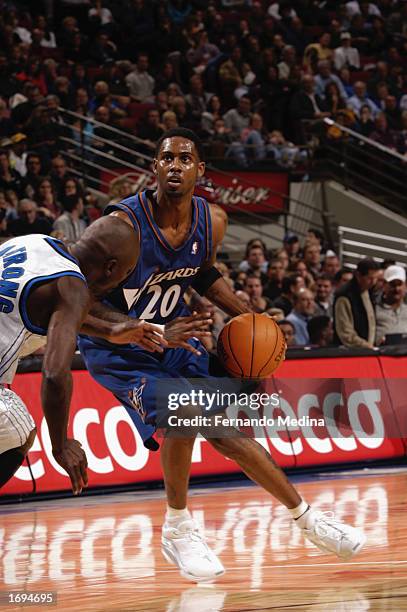 Larry Hughes of the Washington Wizards drives the ball during the NBA game against the Orlando Magic at TD Waterhouse Centre on December 6, 2002 in...