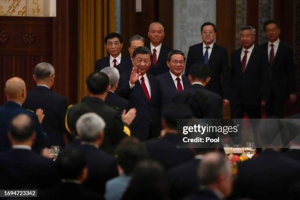 Chinese President Xi Jinping, center left, and Premier Li Qiang, center right, followed by high-ranking Chinese officials, arrive for a dinner...