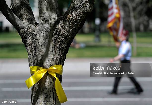Yellow ribbons were tied to many of the trees along Broadway. The annual City and County of Denver Memorial Day Parade and Tribute winds its way...
