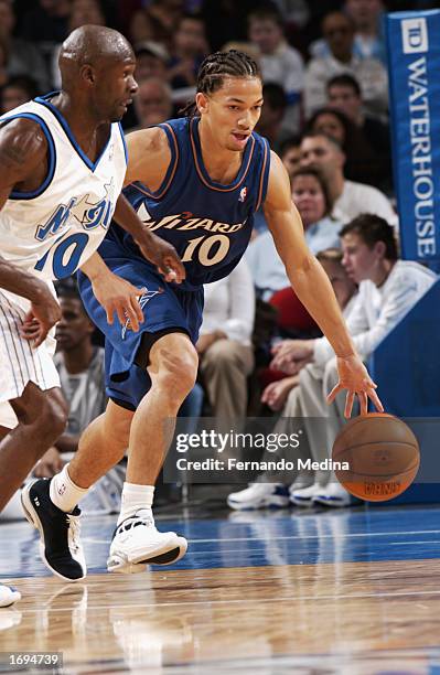 Tyronn Lue of the Washington Wizards drives the ball during the NBA game against the Orlando Magic at TD Waterhouse Centre on December 6, 2002 in...