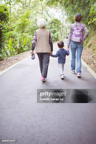 family relaxed in the nature - multi generation family from behind stock pictures, royalty-free photos & images