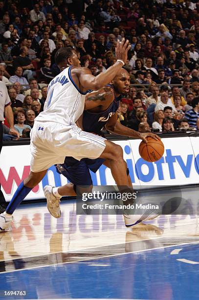 Jerry Stackhouse of the Washington Wizards drives against Tracy McGrady of the Orlando Magic during the NBA game at TD Waterhouse Centre on December...