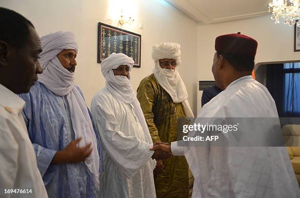 President of Niger Mahamadou Issoufou , greets a member of a delegation of the High Council of the Azawad, a territory in northern Mali, led by...