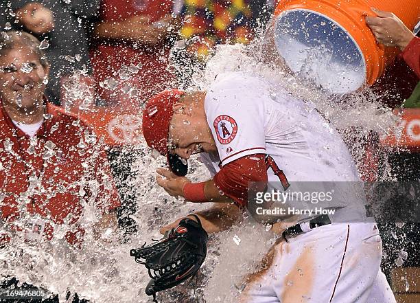 Mike Trout of the Los Angeles Angels is doused with water in celebration of hitting for the cycle after a 12-0 win over the Seattle Mariners at Angel...