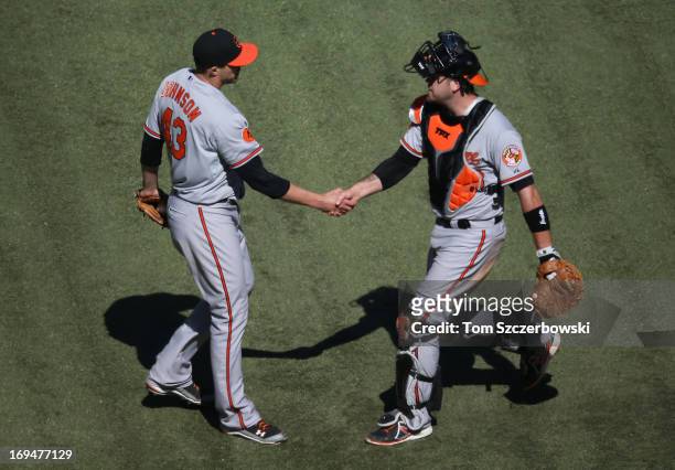 Jim Johnson of the Baltimore Orioles celebrates with Chris Snyder after their victory during MLB game action against the Toronto Blue Jays on May 25,...