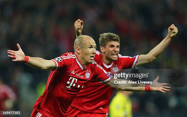 Arjen Robben of Bayern Muenchen celebrates with team-mate Thomas Mueller after scoring a goal during the UEFA Champions League final match between...