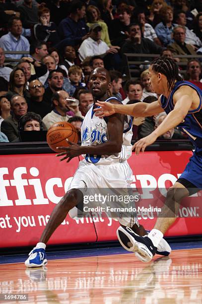 Darrell Armstrong of the Orlando Magic drives against Tyronn Lue of the Washington Wizards during the NBA game at TD Waterhouse Centre on December 6,...