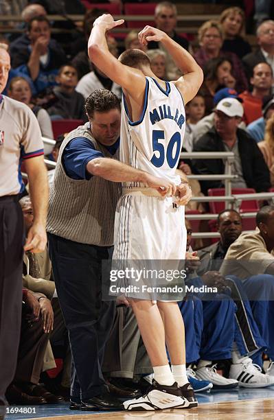 Mike Miller of the Orlando Magic gets his shorts taped by Trainer Ted Arzonico of the Orlando Magic during the NBA game against the Washington...