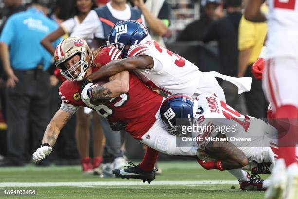 George Kittle of the San Francisco 49ers dives as he is brought down by Isaiah Simmons of the New York Giants during an NFL football game between the...