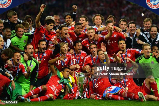 The FC Bayern Muenchen team poses with the trophy after winning the UEFA Champions League final match against Borussia Dortmund at Wembley Stadium on...