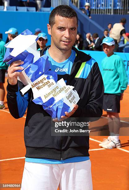 Albert Montanes of Spain holds the trophy after beating Gael Monfils of France in their final match during day seven of the Open de Nice Cote d'Azur...