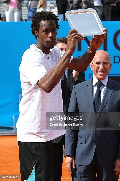 Gael Monfils of France holds the finalist trophy after losing against Albert Montanes of Spain during their final match during day seven of the Open...