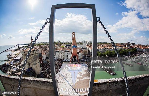 In this handout image provided by Red Bull, Blake Aldridge of the United Kingdom prepares to launch an armstand dive from the 27.5 metre platform on...