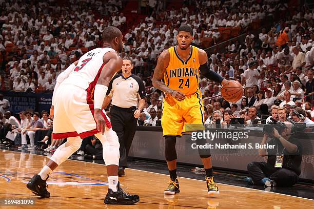 Paul George of the Indiana Pacers dribbles up the court against Dwyane Wade of the Miami Heat in Game One of the Eastern Conference Finals on May 22,...