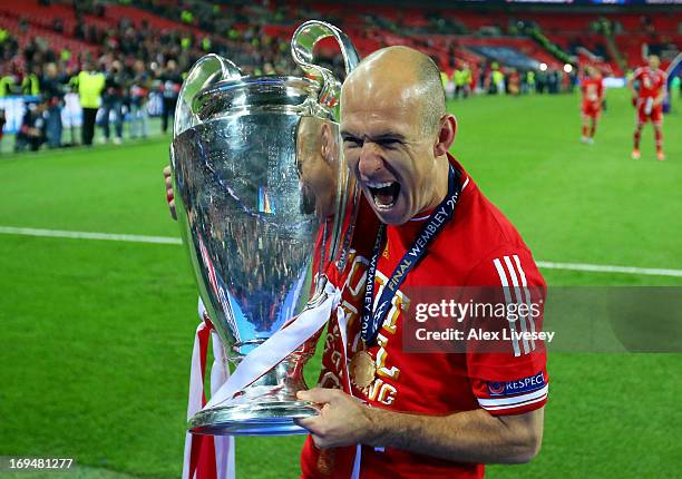 Arjen Robben of Bayern Muenchen holds the trophy after winning the UEFA Champions League final match against Borussia Dortmund at Wembley Stadium on...