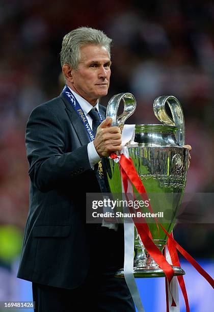 Head Coach Jupp Heynckes of Bayern Muenchen holds the trophy after winning the UEFA Champions League final match against Borussia Dortmund at Wembley...