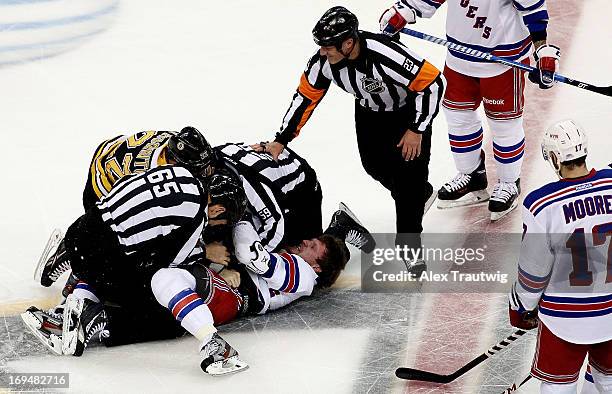 Linesman Pierre Racicot and linesman Steve Barton get tangled in a fight between Shawn Thornton of the Boston Bruins and Derek Dorsett of the New...