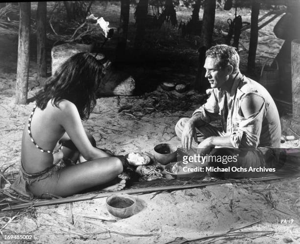 Steve McQueen develops a loving relationship with a young Indian girl in a scene from the film 'Papillon', 1973.