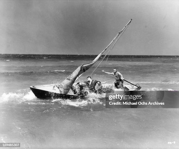 Steve McQueen combat waves while trying to manage the boat in a scene from the film 'Papillon', 1973.